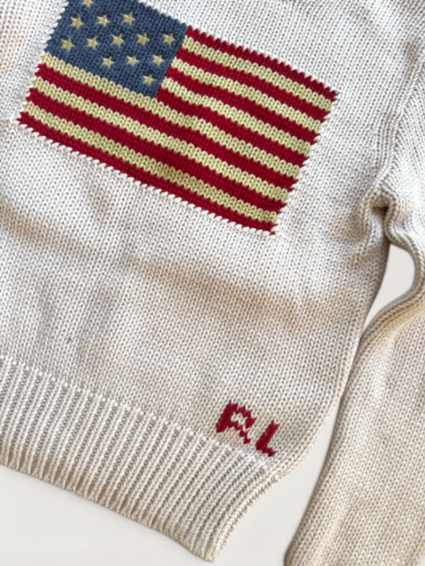 Jungs & Deerns Polo Ralph Lauren Baumwollpullover in Creme mit eingestrickter USA-Flagge und rotem RL-Logo am Saum